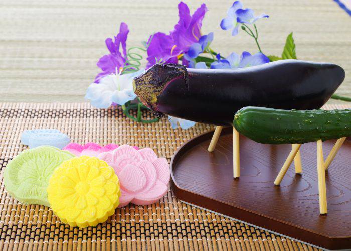 A spirit horse and cow; an Obon decoration whereby eggplant and cucumber are given little wooden legs.